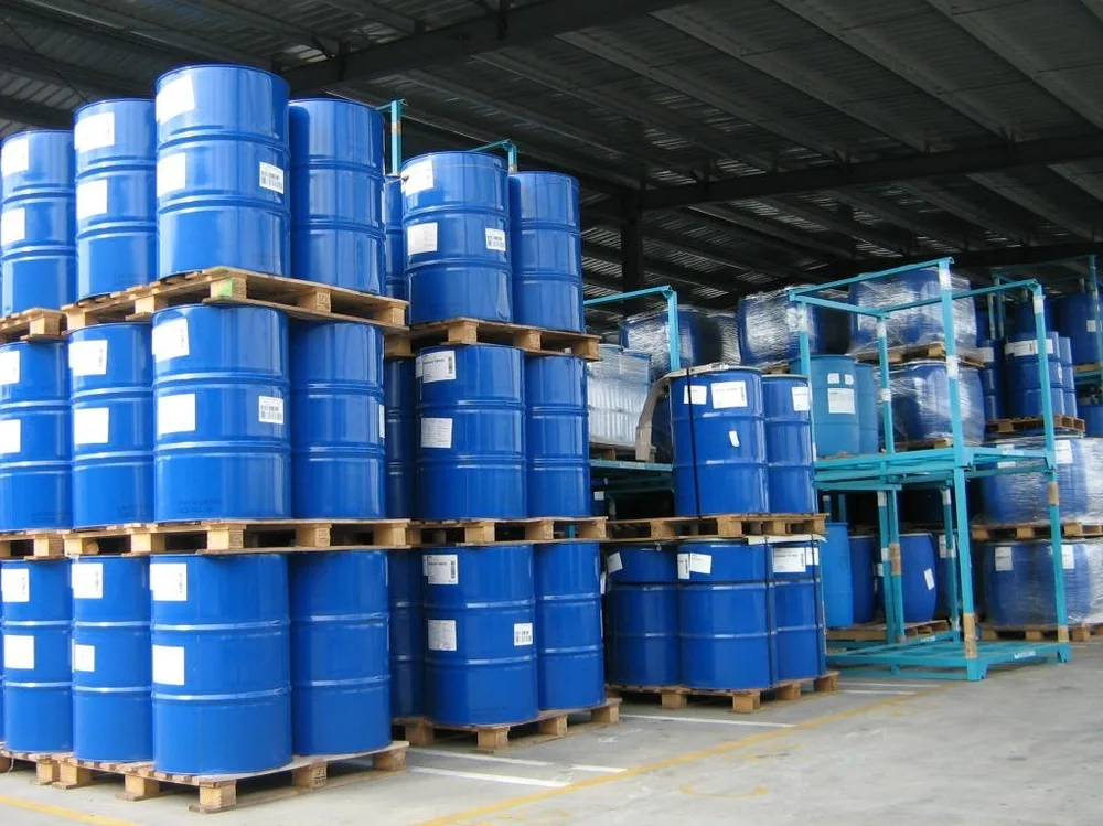 Stacked industrial chemical drums in warehouse storage